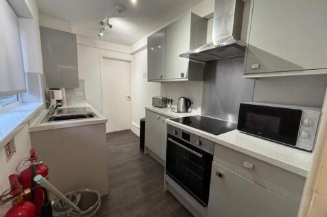 Modern kitchen equipped with sleek cabinets and...