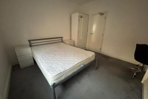 Spacious double bedroom featuring a comfortable...