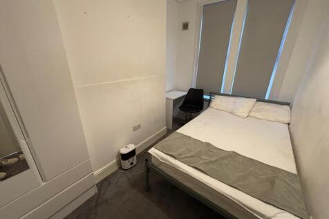 Cozy double bedroom featuring ample natural lig...