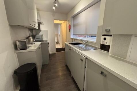 Modern kitchen featuring sleek cabinetry, ample...