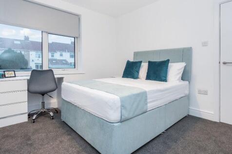This inviting double bedroom features a comfort...