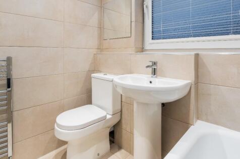 A beautifully designed bathroom featuring moder...