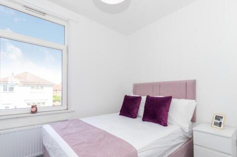 This inviting double bedroom features a cozy am...