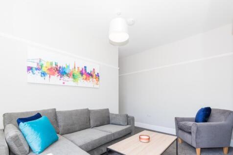 This contemporary living room features a spacio...