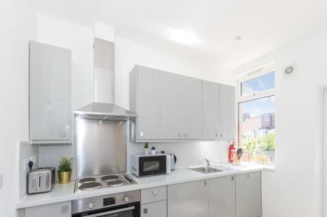This modern kitchen features sleek cabinetry an...