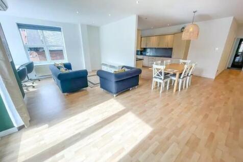 Spacious and bright living room featuring conte...