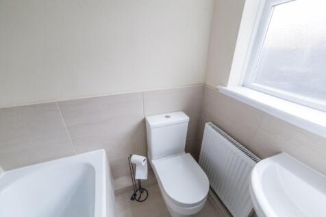 Bright and modern bathroom featuring a spacious...