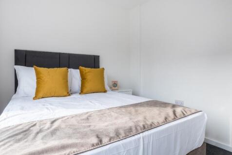 This inviting double bedroom features a comfort...