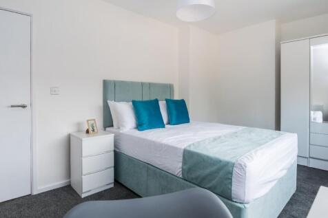 Spacious double bedroom featuring a comfortable...
