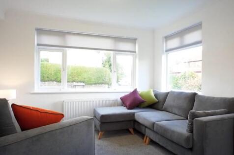 A bright and inviting living room featuring a c...
