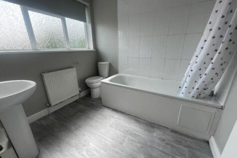 Bright and modern bathroom featuring a spacious...