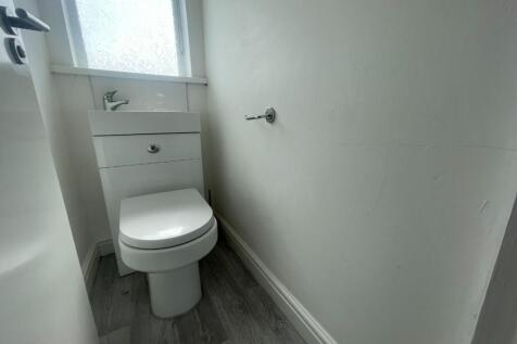 A tidy and functional single toilet with modern...
