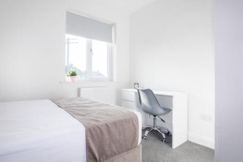 This inviting double bedroom features a cozy at...