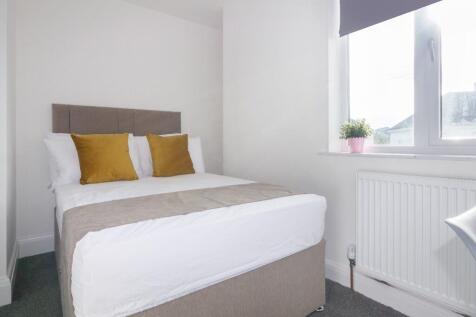 This inviting double bedroom features a comfort...