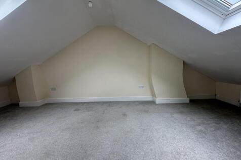 Spacious double bedroom featuring large skyligh...