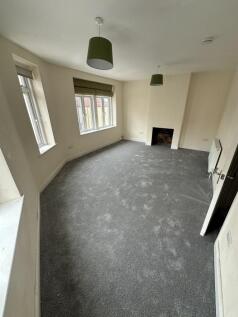 This spacious double bedroom features large win...