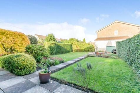 A beautifully maintained garden with lush green...
