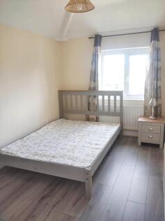 A bright and tidy double bedroom featuring a gr...