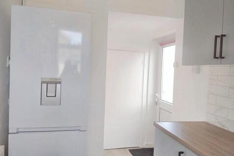 Bright and clean modern kitchen space featuring...