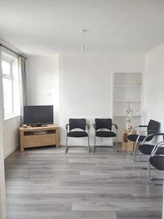 A bright communal lounge featuring modern gray ...