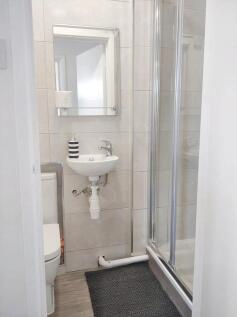 A clean and modern bathroom featuring a compact...