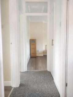 A clean and bright hallway with neutral walls a...