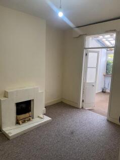 A quiet living room featuring a classic tiled f...