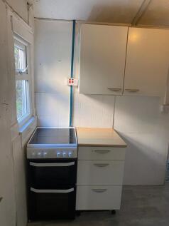 Compact kitchen area featuring a modern electri...