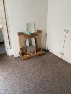 A modest living room featuring a vintage tiled ...