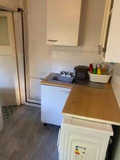 Compact kitchen area featuring a stainless stee...