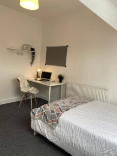 Spacious double bedroom featuring a comfortable...