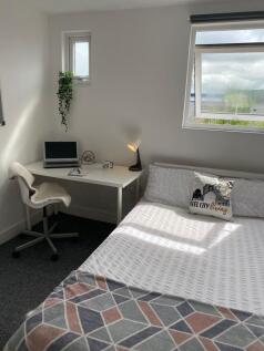 A stylish and cozy double bedroom featuring a c...