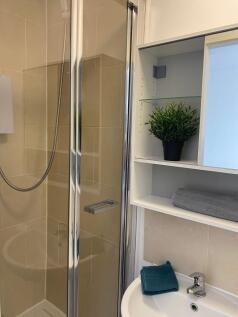 A modern bathroom featuring a sleek shower encl...