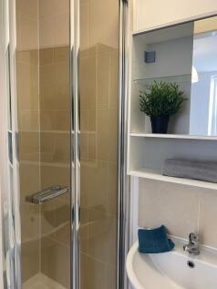 This modern bathroom features a sleek shower en...