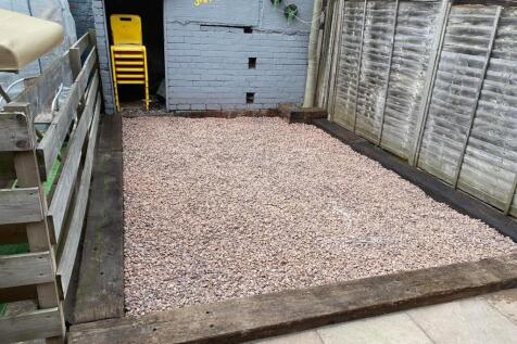 A well-maintained garden area featuring a spaci...