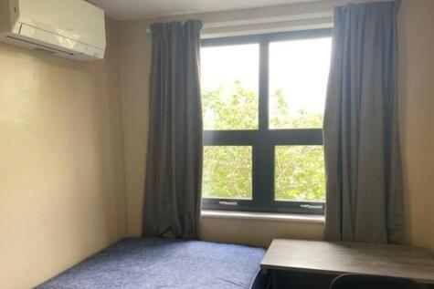 A bright and cozy double bedroom featuring a st...