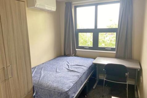 This inviting double bedroom features a comfort...