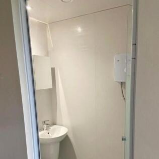 A modern and clean bathroom with a shower, perf...