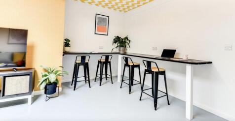 A stylish communal workspace featuring a sleek ...