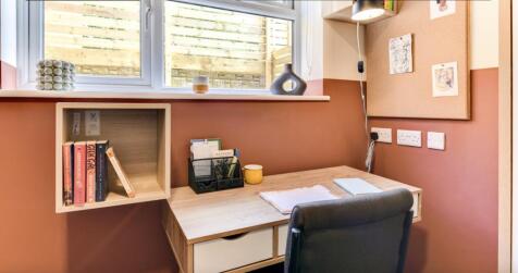 A cozy and well-lit communal workspace featurin...