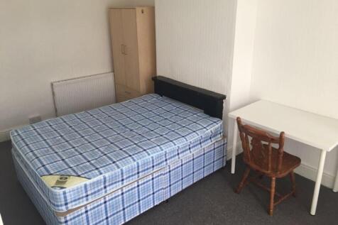 This inviting double bedroom features a comfort...