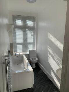 Bright and modern bathroom featuring a stylish ...