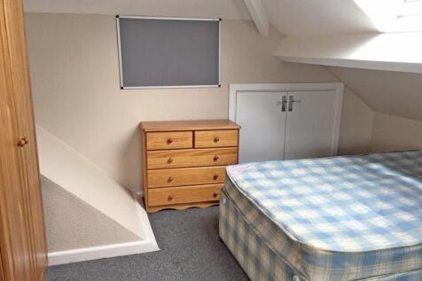 This cozy double bedroom features a comfortable...