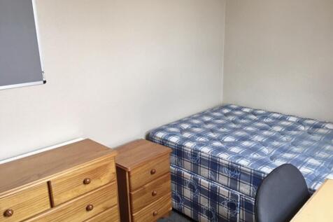 Cozy double bedroom featuring a comfortable bed...