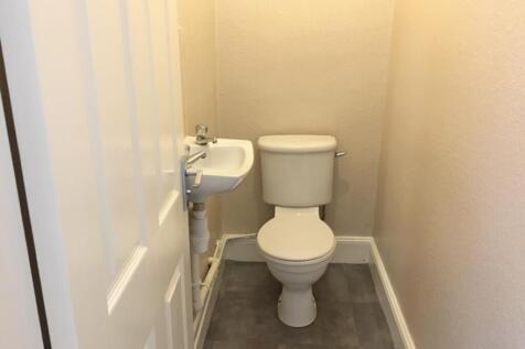 A well-maintained single toilet featuring a cle...