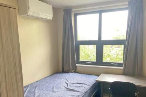 A bright and tidy double bedroom featuring a co...