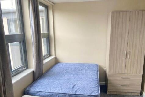A bright and inviting double bedroom with large...