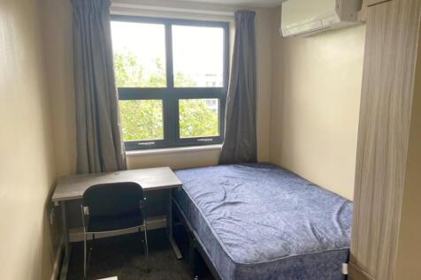 This inviting double bedroom features a comfort...