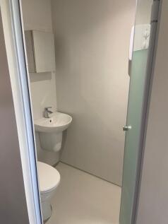 A sleek and modern bathroom featuring a clean d...