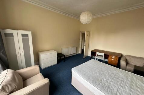 A spacious and inviting double bedroom with amp...